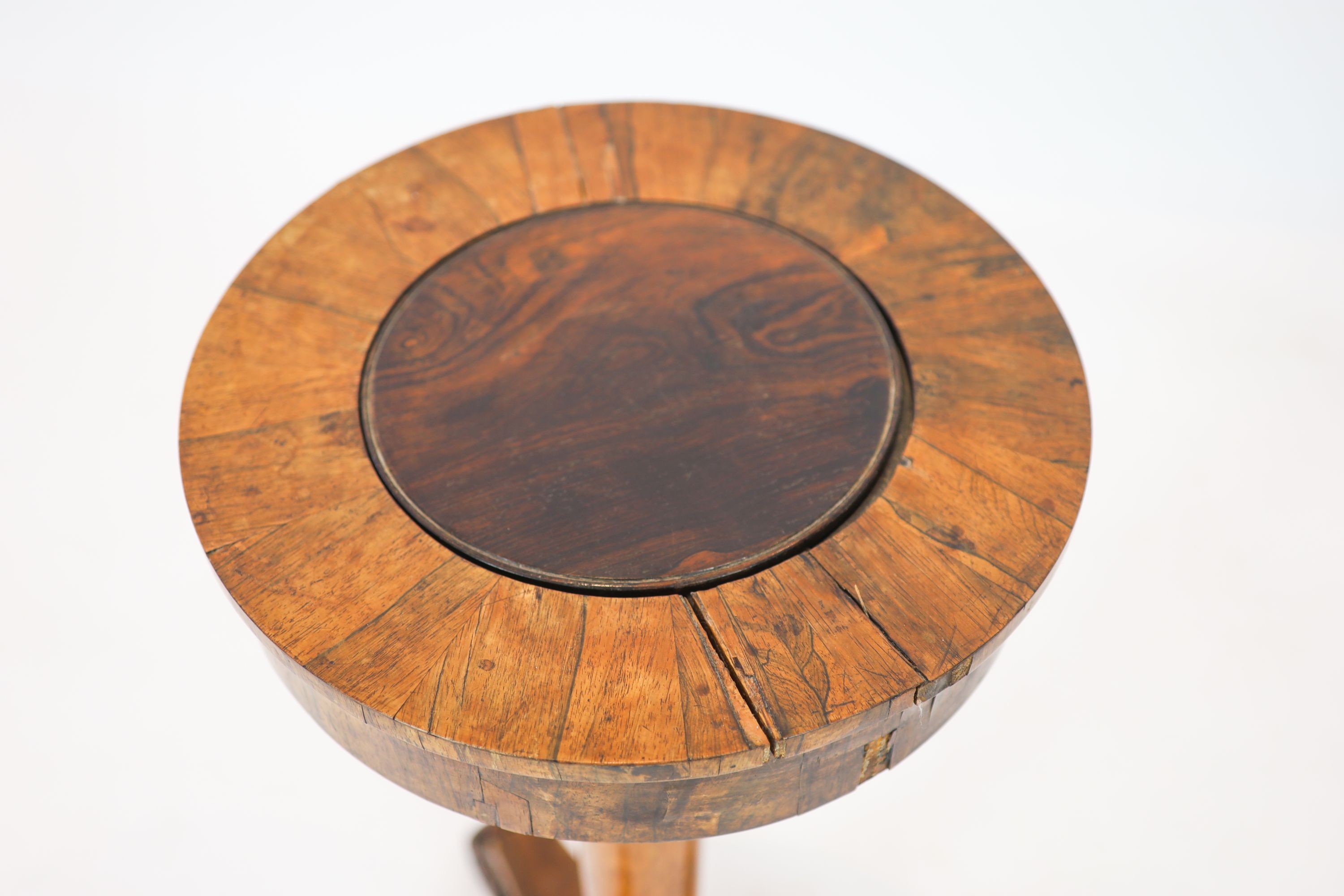 A Regency banded rosewood circular topped work table, raised on tapered, turned pillar, on a triform platform base, diameter 40cm, height 75cm